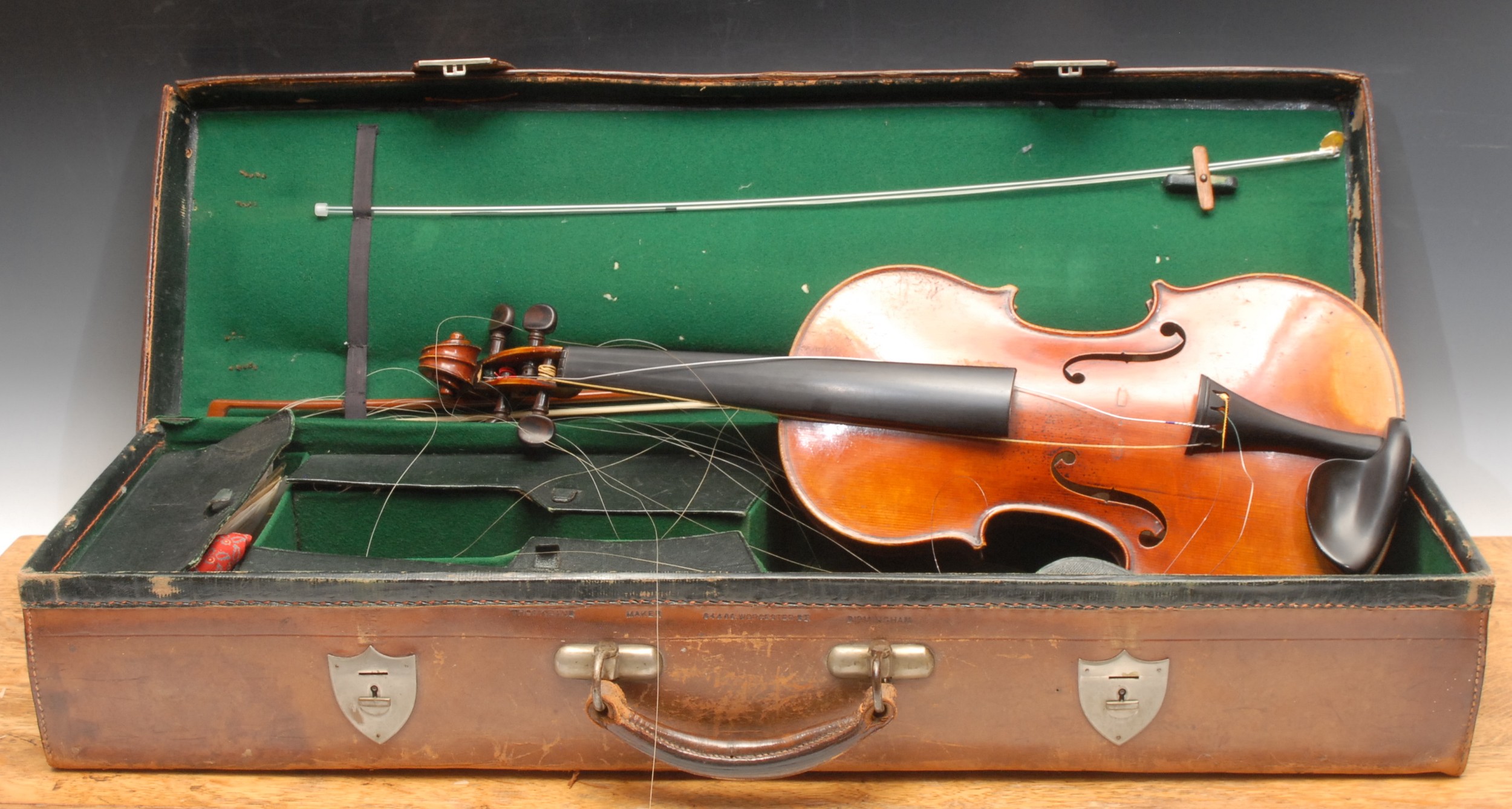 A violin, the one-piece back 36cm long excluding button, the interior stamped and with paper label printed Honore Derazy père a Mirecourt, rosewood tuning pegs, outlined throughout with purfling, 60.5cm long overall, the bow stamped Tourte, 75cm long, early 20th century fitted leather case