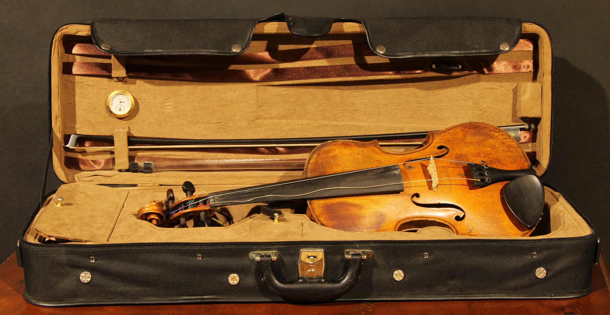 A violin, the two-piece back 35.5cm long excluding button, paper label printed Joseph Guarnerius, rosewood tuning pegs, outlined throughout with purfling, 60cm long, modern bow and case