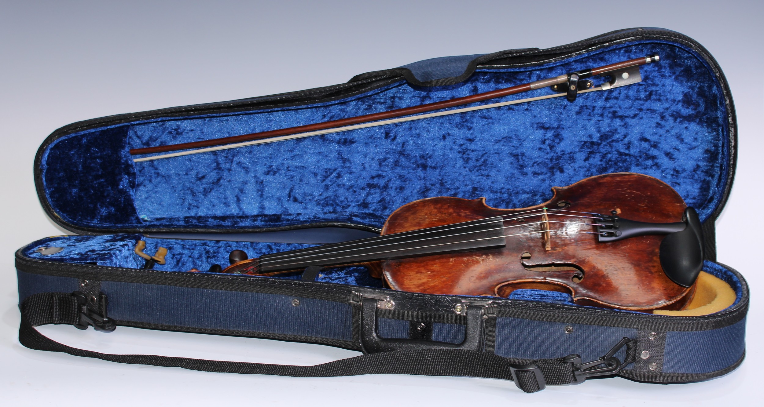 A 19th century violin, 35.6cm two-piece back excluding button, outlined with tramline purfling, carved scroll, rosewood tuning pegs, 60cm long overall; the mahogany bow by Tubbs, stamped, rosewood and mother-of-pearl marquetry frog, 73cm long; the later case labelled: Hill and Company, Welwyn, Hertfordshire
